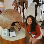 Assata standing next to Glyptodon